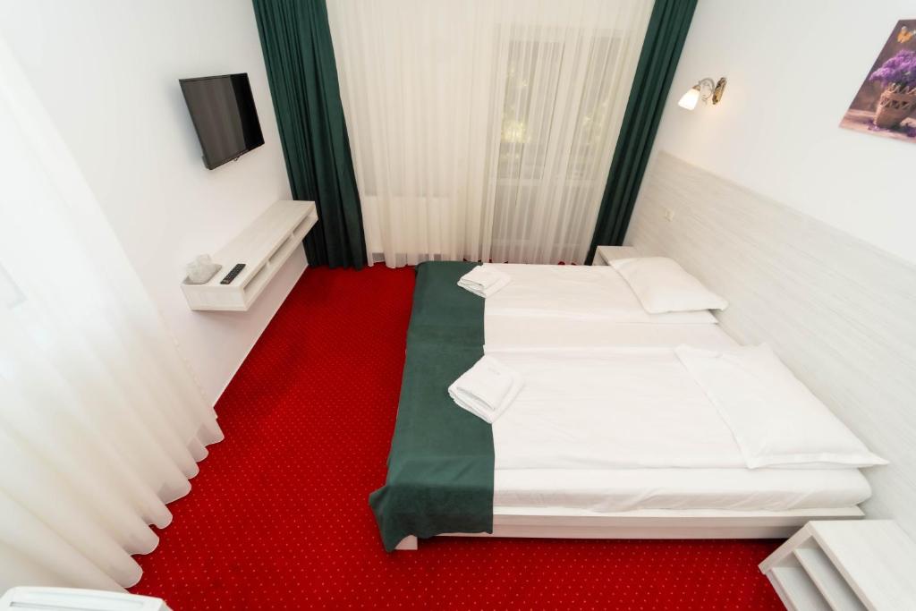 Postel nebo postele na pokoji v ubytování Hotel Cirus
