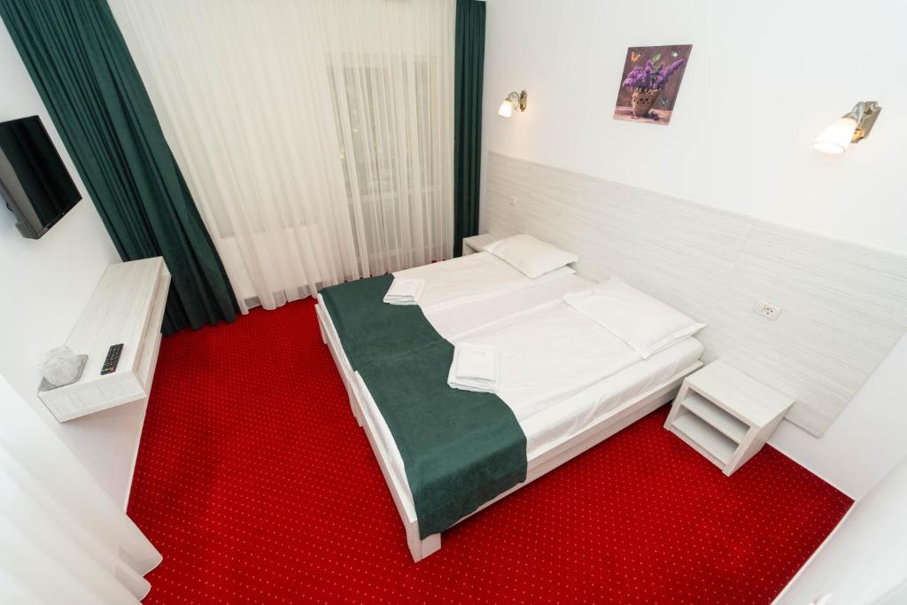 Postel nebo postele na pokoji v ubytování Hotel Cirus