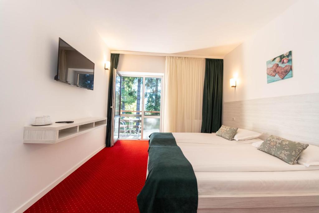 Postel nebo postele na pokoji v ubytování Hotel Cirus