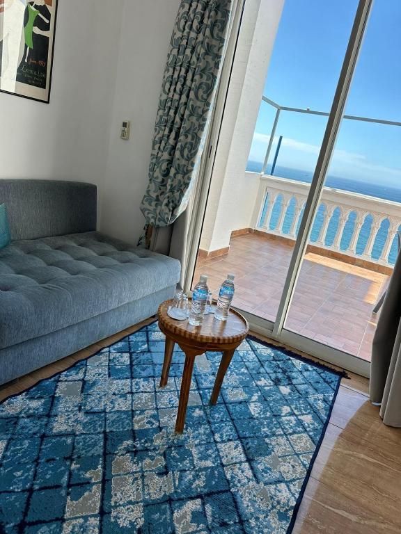 a living room with a couch and a table at Riad Ras Lafaa in Safi