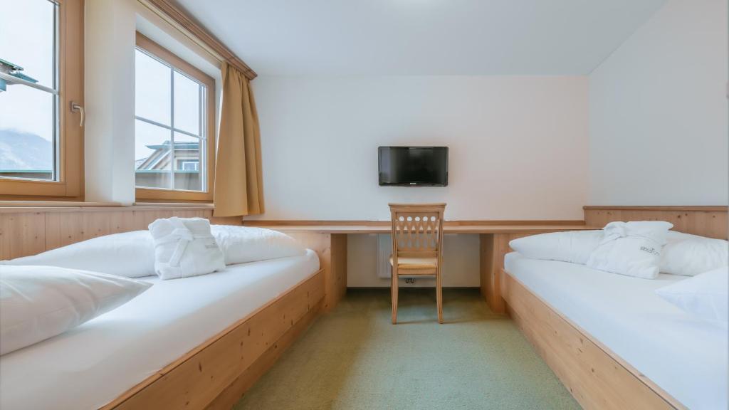 Postel nebo postele na pokoji v ubytování KERSCHDORFER - wohlfühlhotel garni - adults only