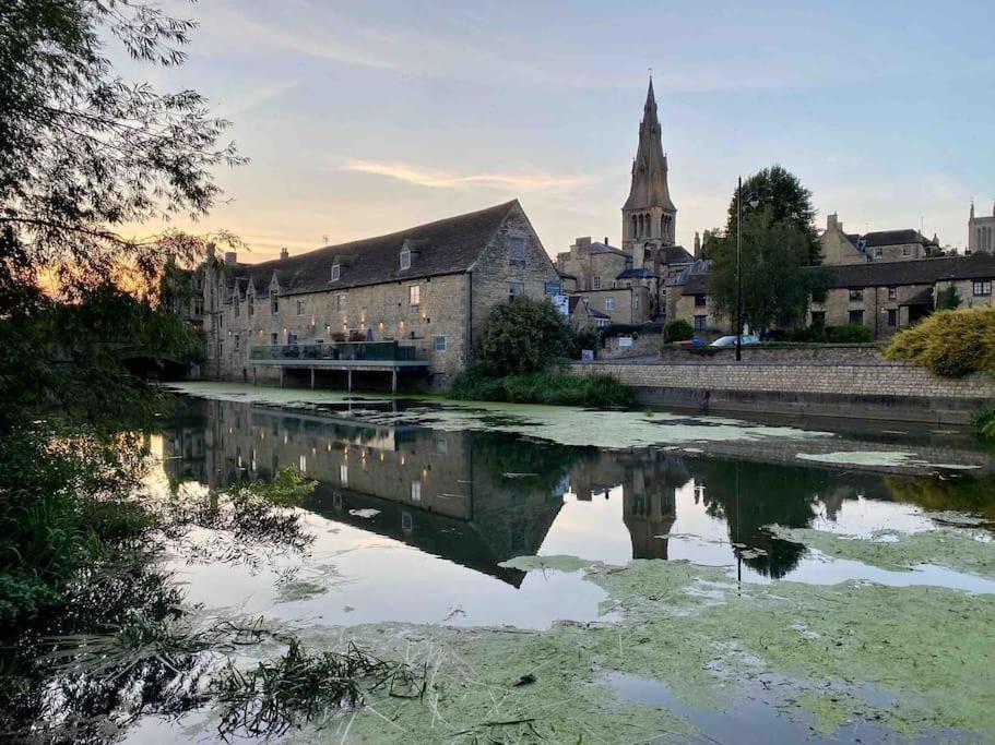 a city with a river in front of a building at Beautiful Stamford Townhouse with River Views in Lincolnshire