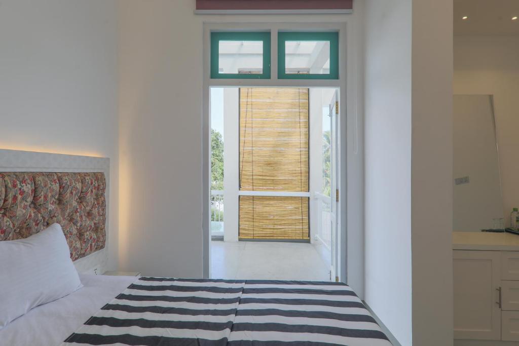 Postel nebo postele na pokoji v ubytování ProEye Apartments - Galle