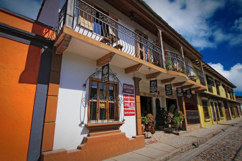 a row of buildings with balconies on a street at Plaza Yat B'alam in Copán Ruinas