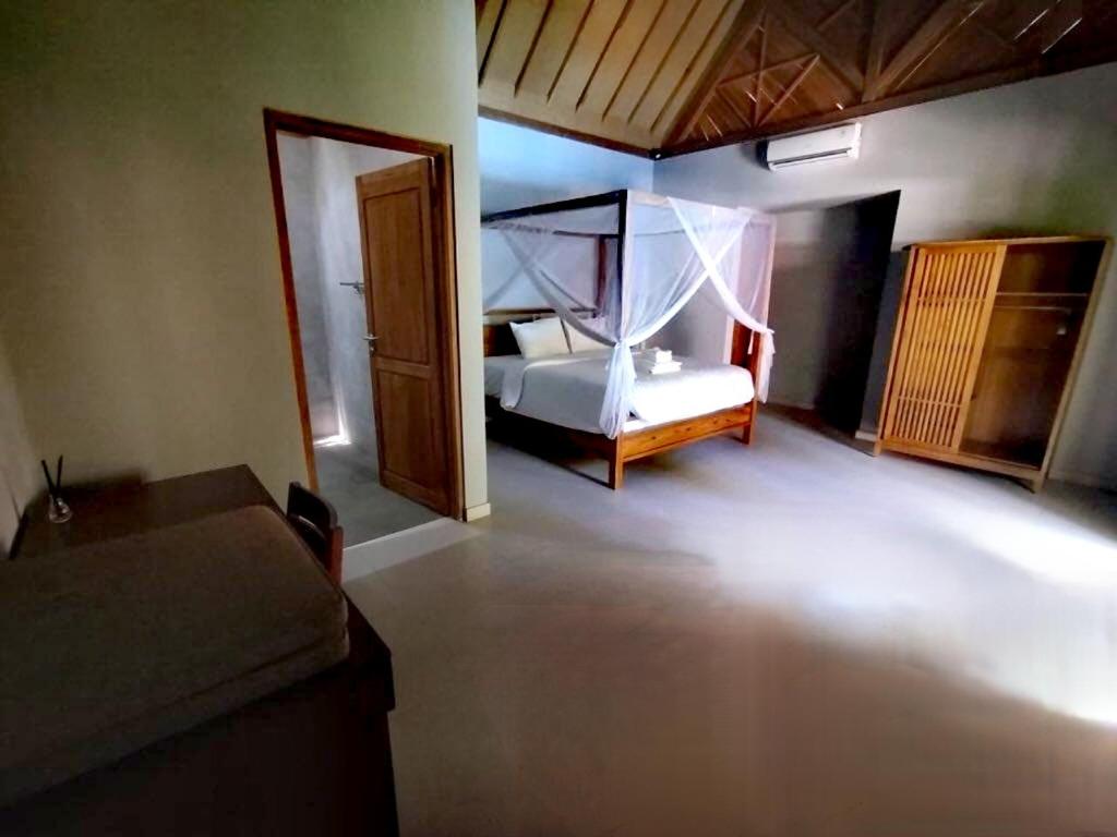 Postel nebo postele na pokoji v ubytování Villa Lova Sambirenteng