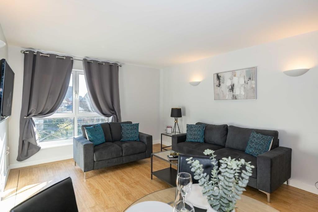 a living room with a couch and a chair at Cotels Centro Budget Busting Apartments! CENTRAL LOCATION, PARKING, FIBRE WIFI, SMART TV, FULLY EQUIPPED KITCHEN in Northampton