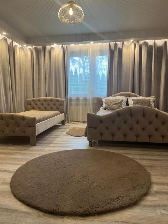 a living room with two couches and a rug at Apartamenty Arkadia przy Amfiteatrze in Mrągowo
