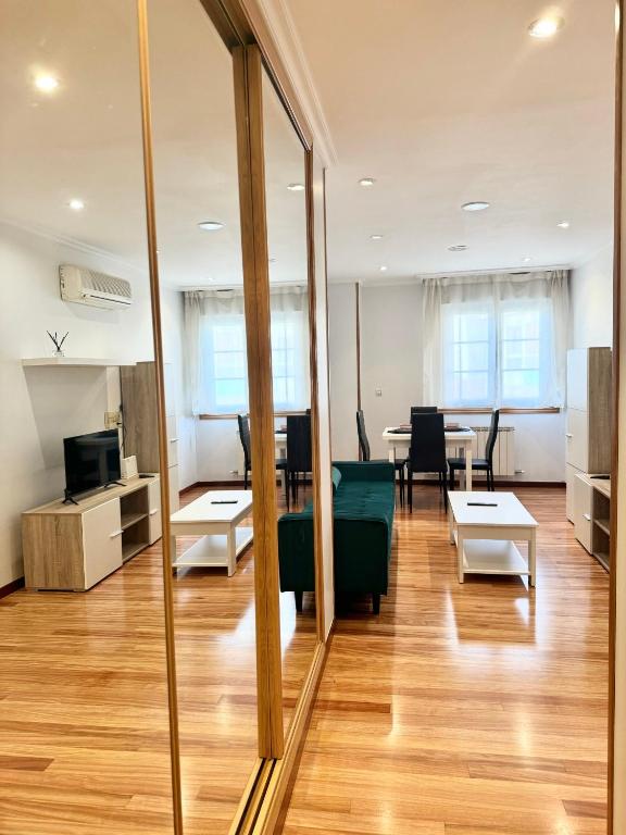 a mirror in an office with a couch and a table at La Perla del Castro in Vilagarcia de Arousa
