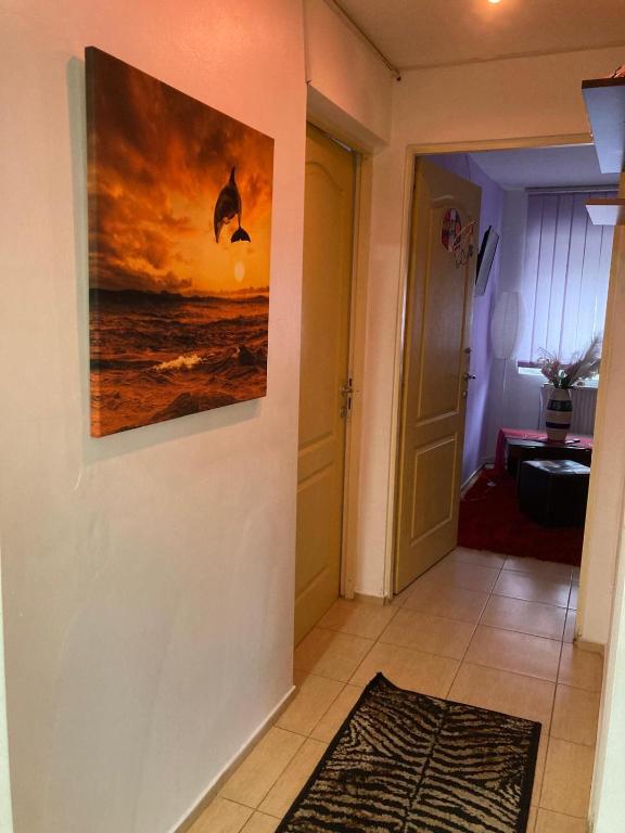 a hallway with a painting hanging on a wall at Apartment boulevard Cetate in Alba Iulia