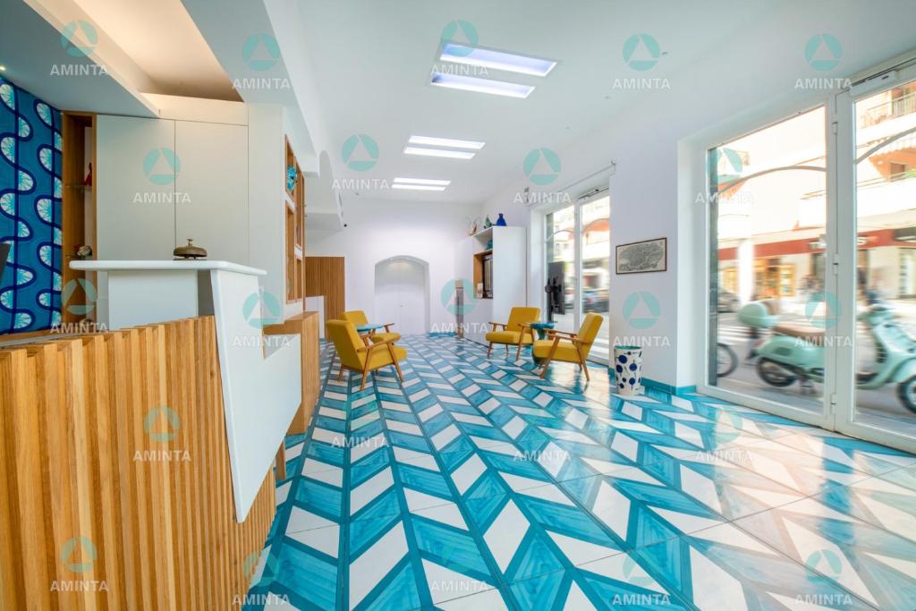 a hospital hallway with blue and white flooring at Hotel Nice in Sorrento