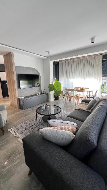 a living room with a couch and a table at Leos Apartments Apart1 in Side