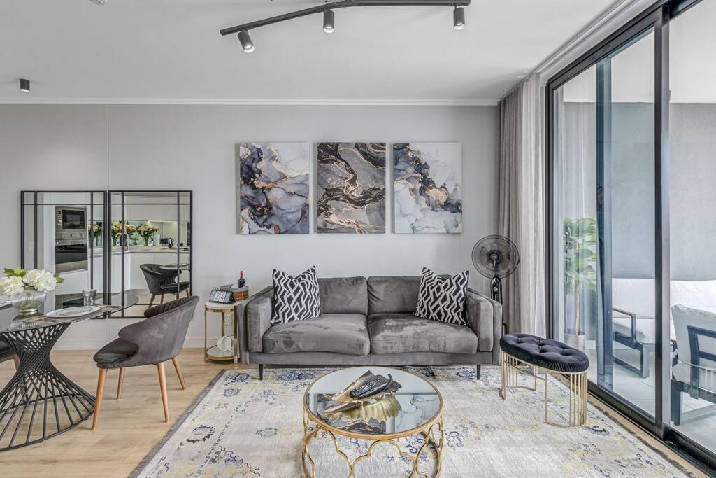 a living room with a couch and a table at Kgothatso's Escape ,1 bed Condo in Midrand