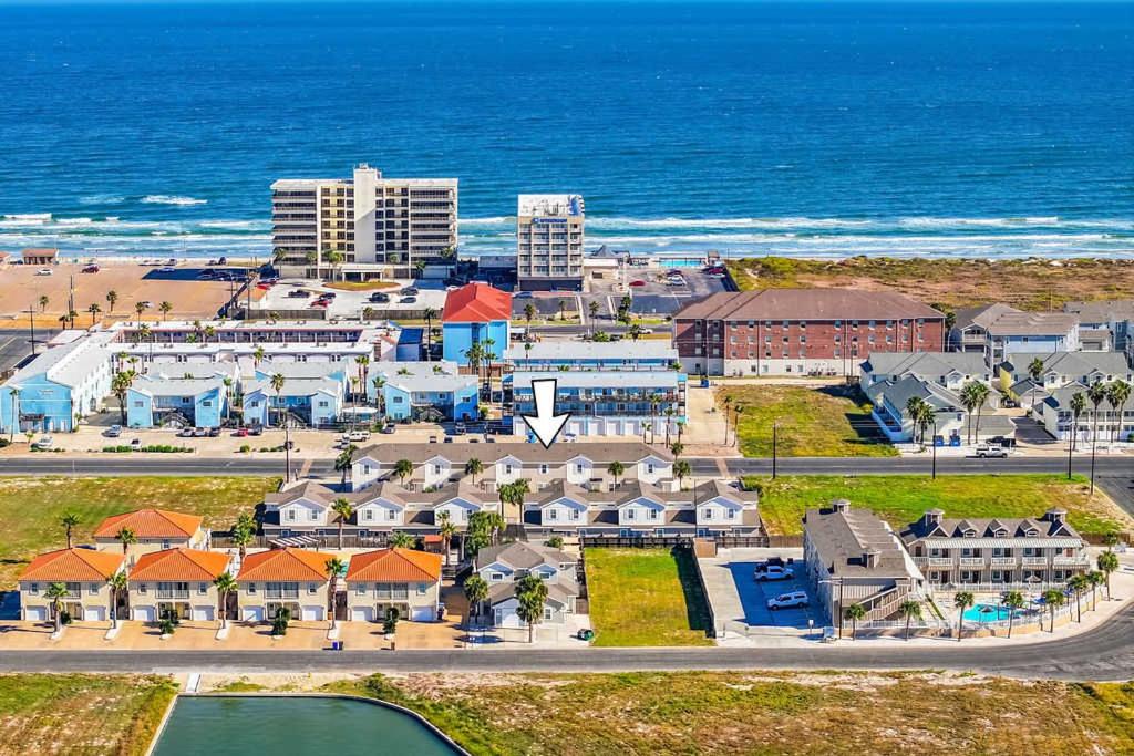 an aerial view of a resort near the ocean at Walk to Beach Shared Pool & Grill Dog Friendly in Padre Island