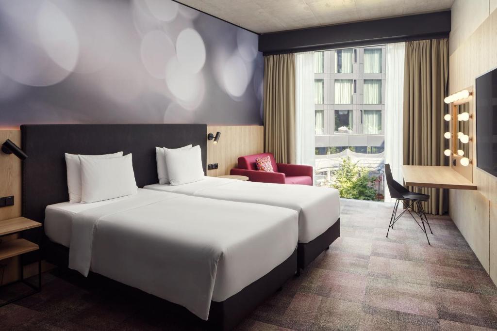 a hotel room with a large bed and a window at STAGES HOTEL Prague, a Tribute Portfolio Hotel in Prague