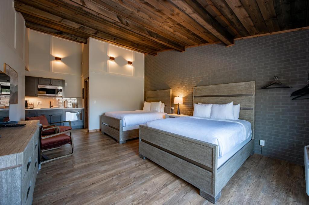a hotel room with two beds and a kitchen at Cove Creek Lodge 202 Poolside Double Queen Room in Oakland