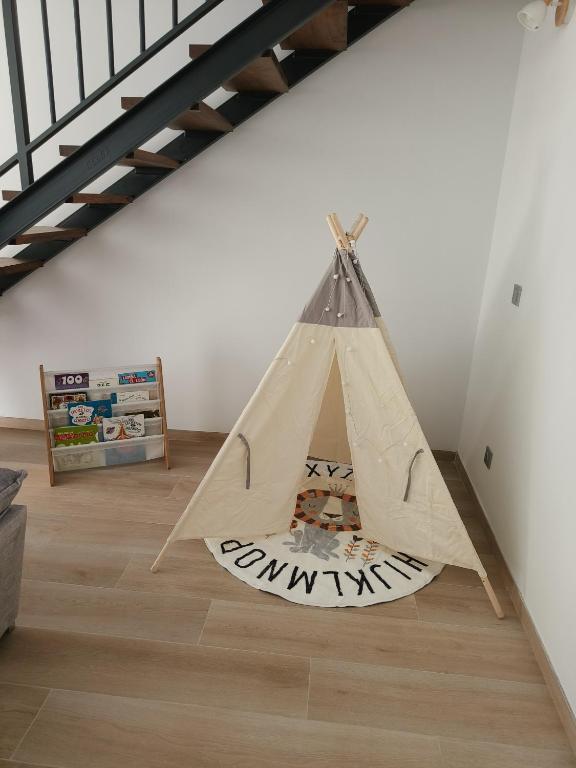 a teepee tent in the middle of a room at Quirós Villa Tranquila de Salcedo 1 in La Villa