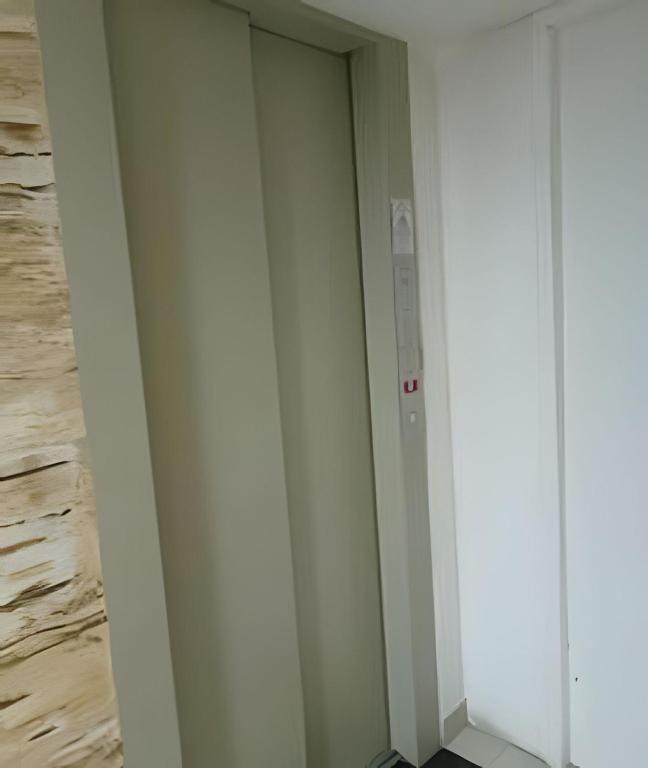 a door in a room with a wall at otimo apart 2 quartos no recreio dos bandeirantes in Rio de Janeiro