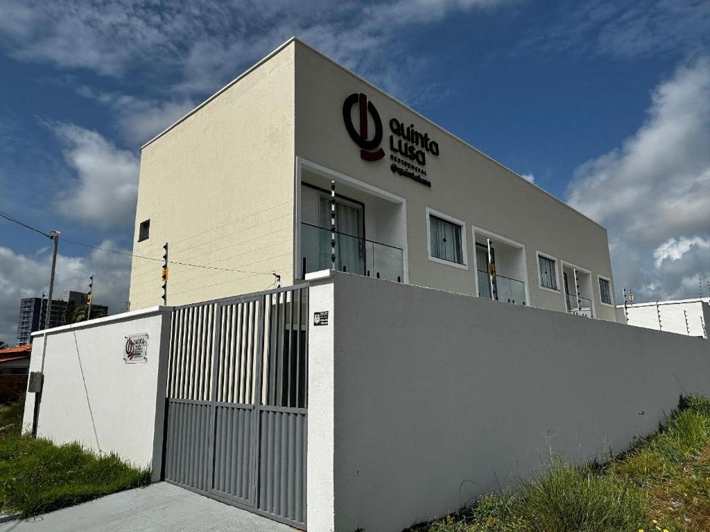a building with a sign on the side of it at Residencial Quinta Lusa em Cond. Valle do Sal - Pox. Gav Resort e Aqualnd - Casas mobilhadas, confortáveis e seguras para passar momentos maravilhosos no Atalaia.. in Salinópolis