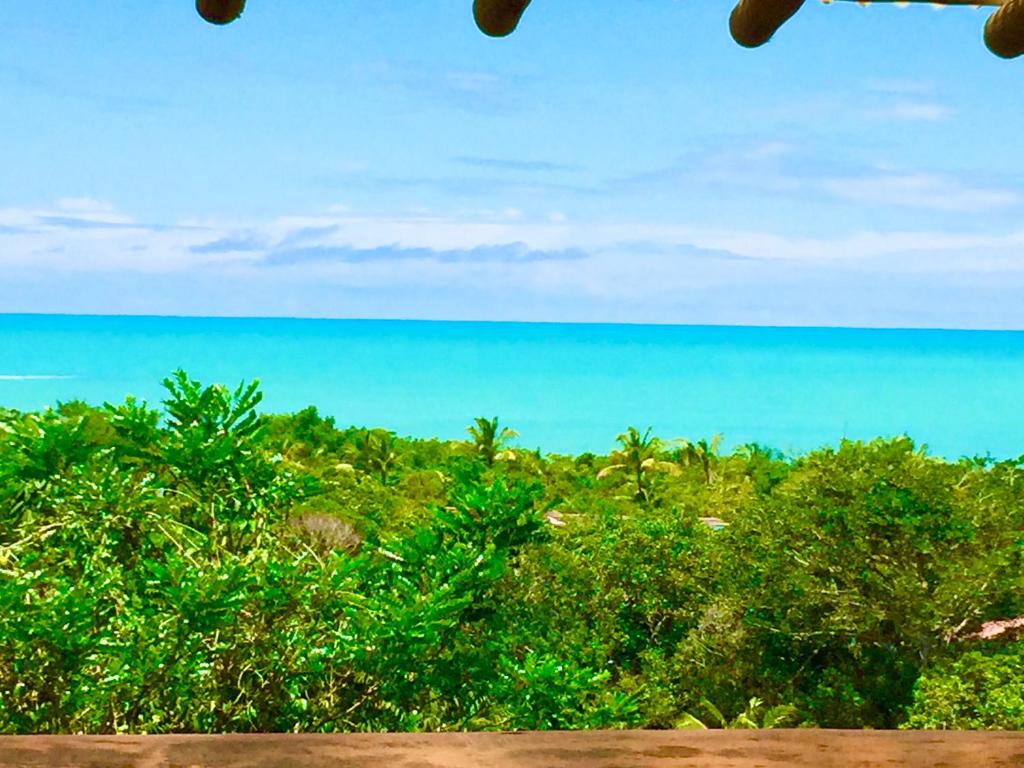 a view of the ocean from the beach at Bangalô Maria Vista Mar, Luxo em Trancoso in Porto Seguro