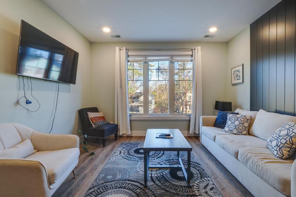 a living room with a couch and a table at Walk to Shops on Front Street Traverse City Condo in Traverse City