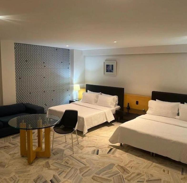 Postel nebo postele na pokoji v ubytování Hotel Ofis Versalles