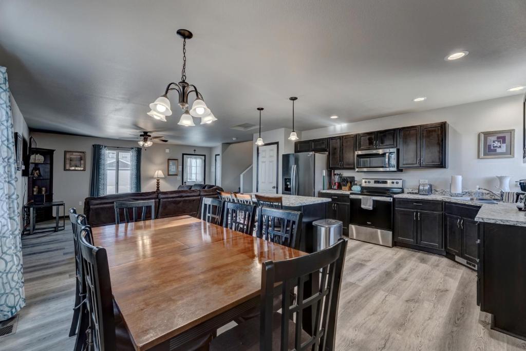 a kitchen with a wooden table and a dining room at Hilltop Family Home w Game Room in Lakota Homes