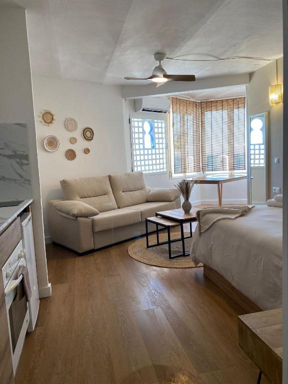 a living room with a bed and a couch at Loft Mojacar Neptuno in Mojácar