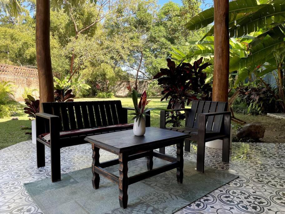 two benches and a table and a table and a bench at PRIVATE OASIS! New Casita with Parking, Garden and Outdoor Kitchen! in Lo de Marcos