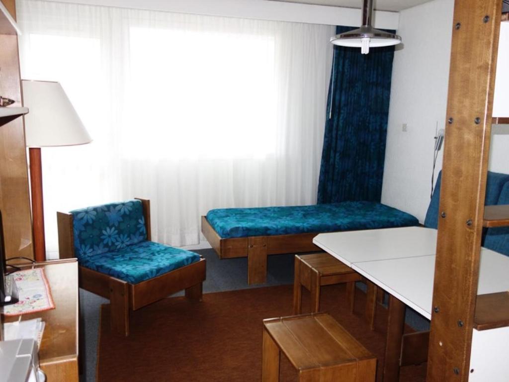 une chambre avec un lit, une table et des chaises dans l'établissement Résidence Kandahar - APPARTEMENT ALPE D'HUEZ AVENUE DU RIF NEL MAE-3621, à Huez