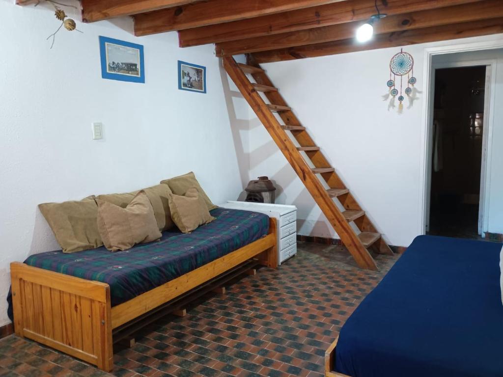 a room with a bed and a ladder in it at Casita del Centro in San Clemente del Tuyú