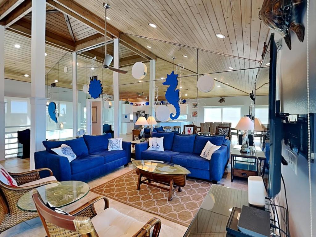 a living room with blue couches and a table at Ocean Pearl in Saint Augustine