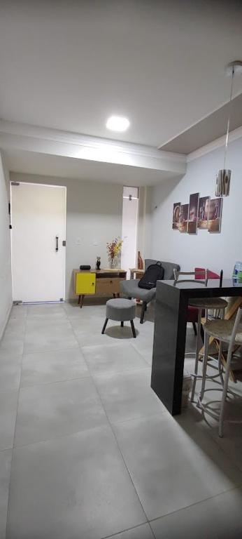 a living room with a door and a table and chairs at Casa Seridó - Caicó in Caicó