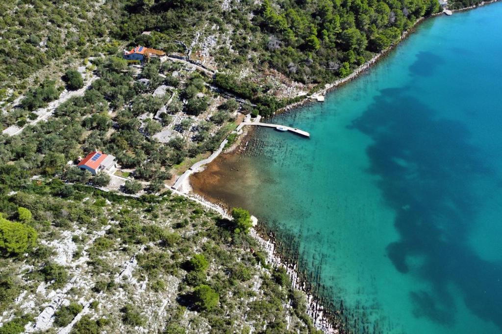an aerial view of a river with a boat in the water at Secluded fisherman's cottage Cove Dragnjevica - Telascica, Dugi otok - 19966 in Sali