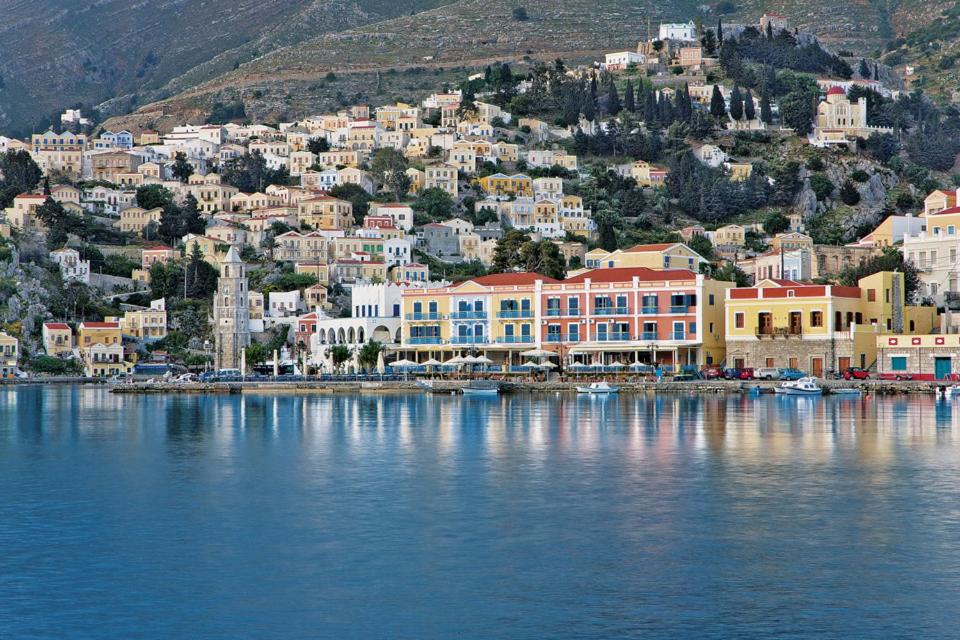 a town on the shore of a body of water at Nireus Hotel in Symi