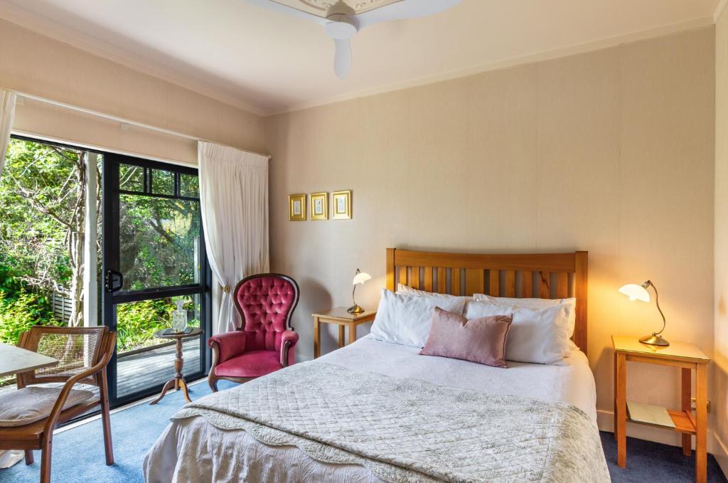 a bedroom with a bed and a large window at Olive Rabbit - Boutique Bed & Breakfast in Turangi