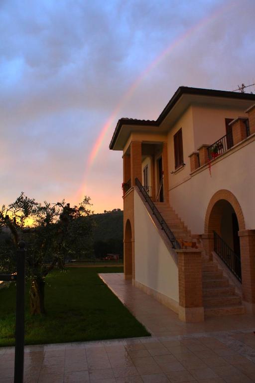 a rainbow in the sky over a house at Residence Stella Del Gran Sasso in Colledara