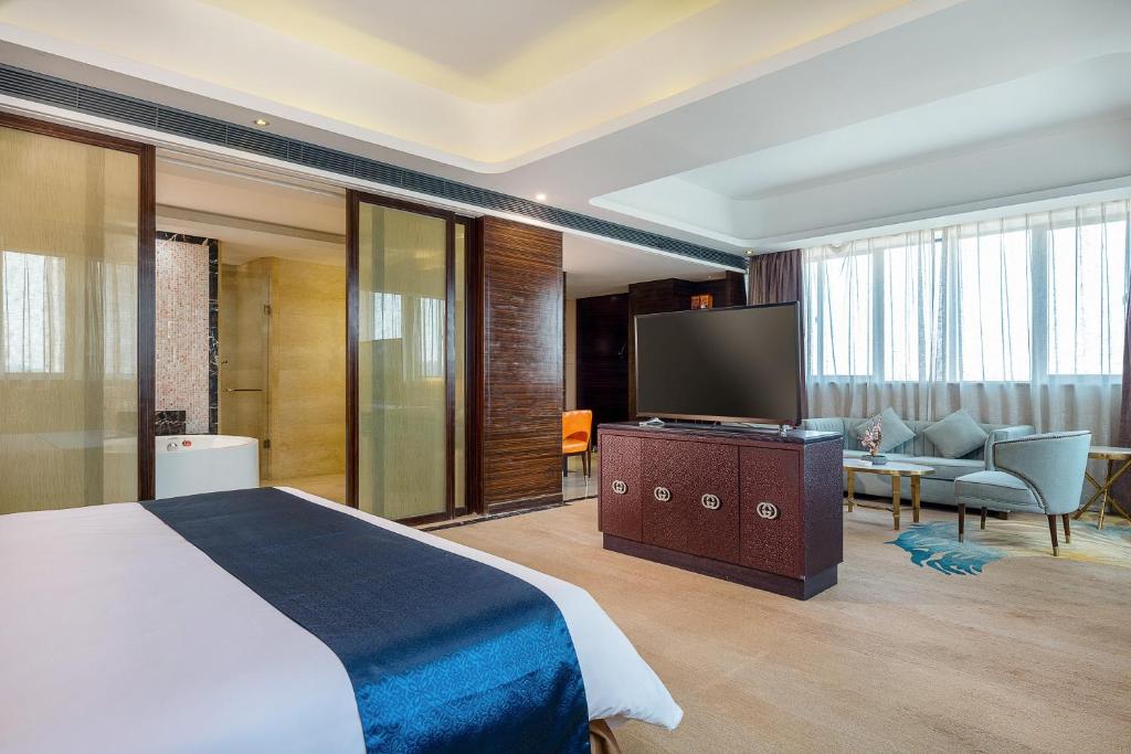 Postel nebo postele na pokoji v ubytování Dongguan Kai Benli International Hotel