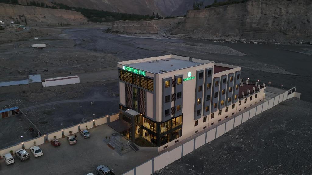 an overhead view of a building with cars in a parking lot at Fortune One Hotel in Hunza