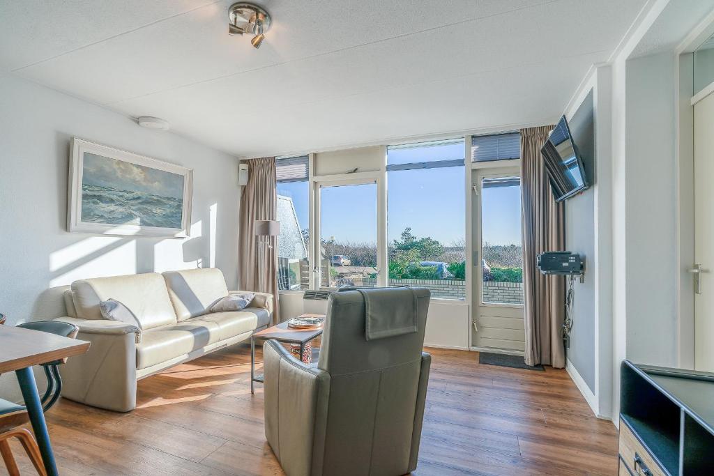 a living room with a couch and a table at Appartementencomplex Juliana 78 in De Koog