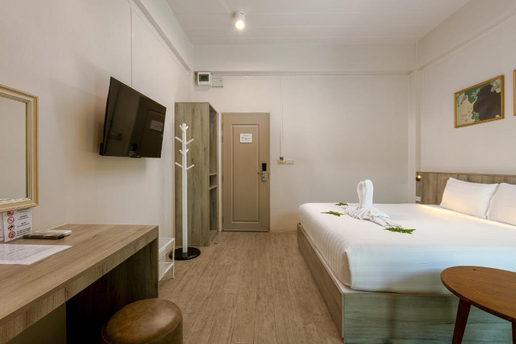 Postel nebo postele na pokoji v ubytování Ang Pao Hotel Phuket