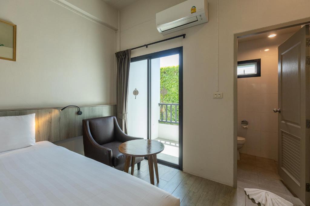Postel nebo postele na pokoji v ubytování Ang Pao Hotel Phuket