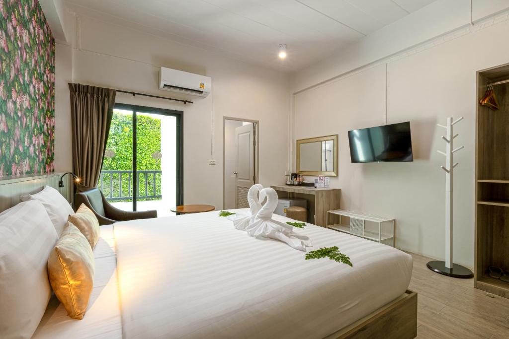 Postel nebo postele na pokoji v ubytování Ang Pao Hotel Phuket