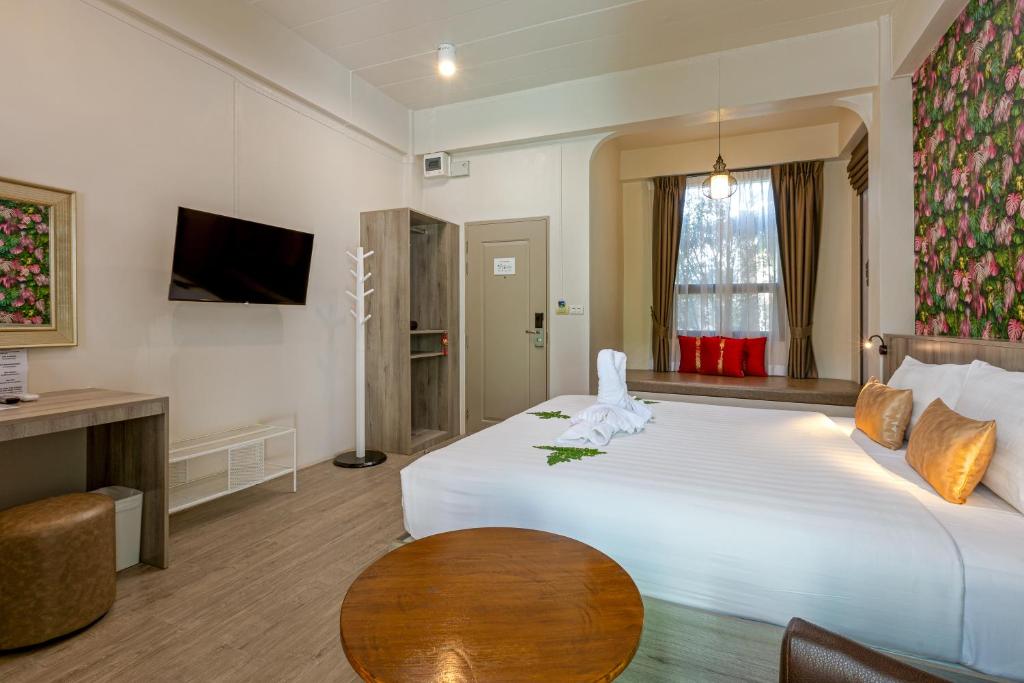 Postel nebo postele na pokoji v ubytování Ang Pao Hotel Phuket