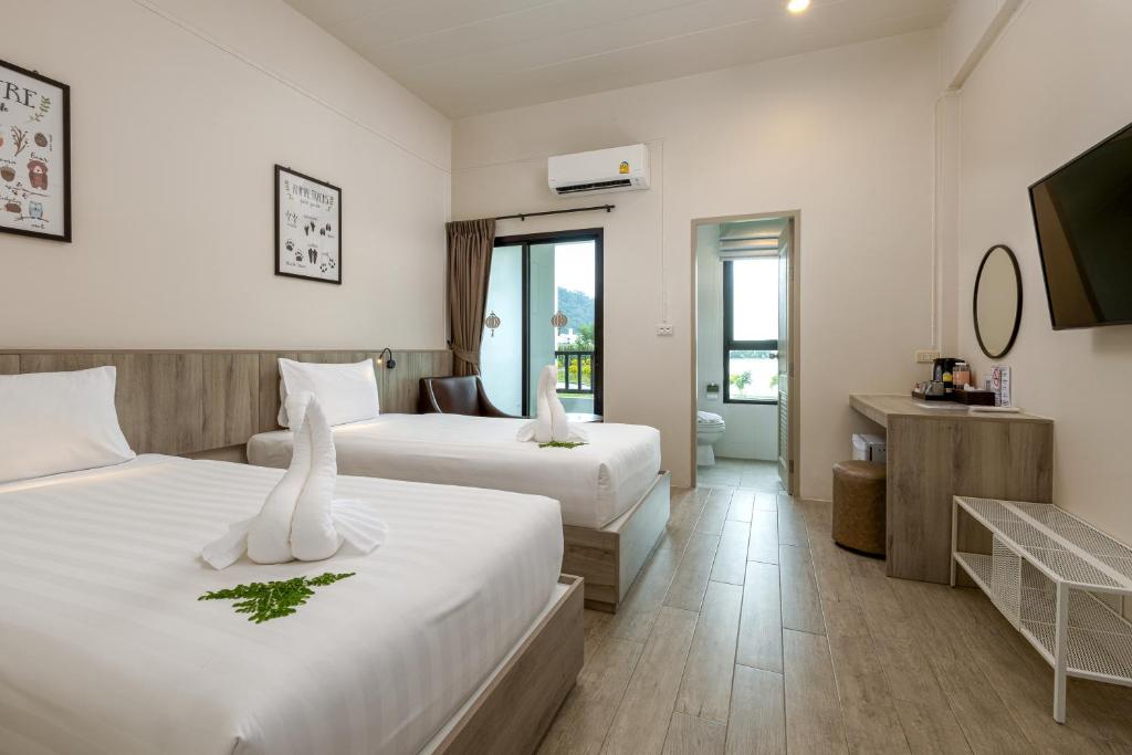 Postel nebo postele na pokoji v ubytování Ang Pao Hotel Phuket