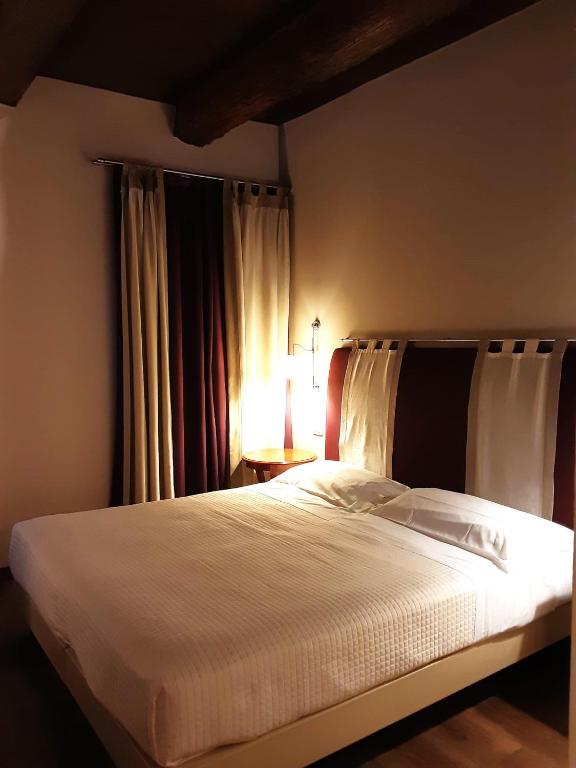 Postel nebo postele na pokoji v ubytování Hotel Antico Podere Propano