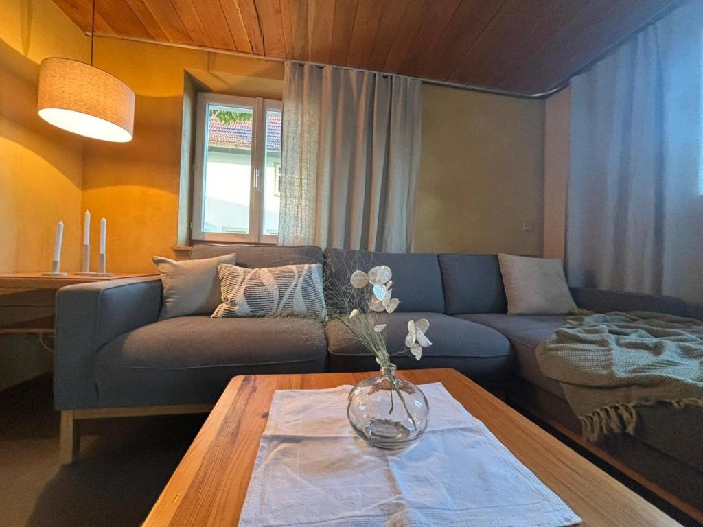 a living room with a blue couch and a table at Ferienhaus Streuglück in Oberstreu