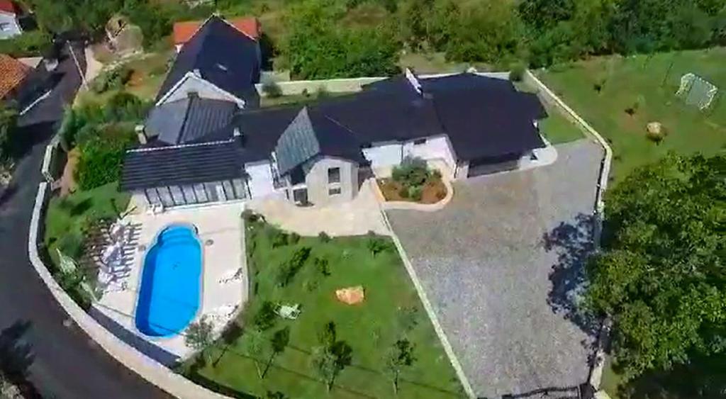 an aerial view of a house with a blue pool at Residence Herzegovina in Široki Brijeg