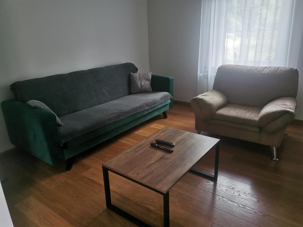 a living room with a couch and a coffee table at Leśna Chatka in Śmigiel