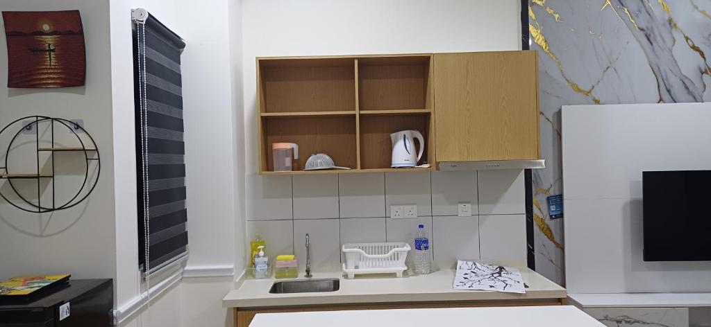 a kitchen with a sink and a counter top at HABITUS Elmina Denai Alam in Shah Alam
