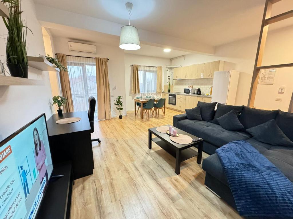 a living room with a couch and a table at Lipatti 15 Premium Apartments by GLAM APARTMENTS in Timişoara